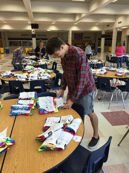 Jack Figy, senior, picks up his powderpuff shirt. This year there was a lot of controversy surrounding the design and decisions made regarding the junior and senior powderpuff shirts.