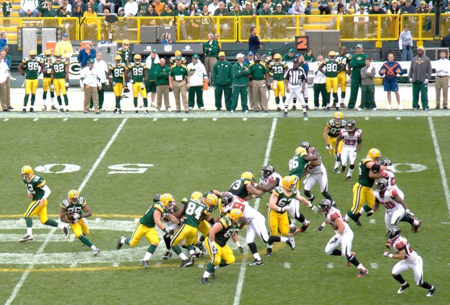 Aaron Rodgers (12) hands the ball off to Ryan Grant (25) in a 2008 regular season game against the Atlanta Falcons. Aaron Rodgers had a huge day on the ground, setting a personal record with 60 rushing yards in yesterday’s game against Atlanta