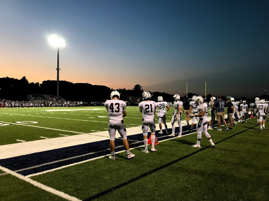 Photo taken by Megan Kitzman. Players standing on the sidelines eager to hit the field.