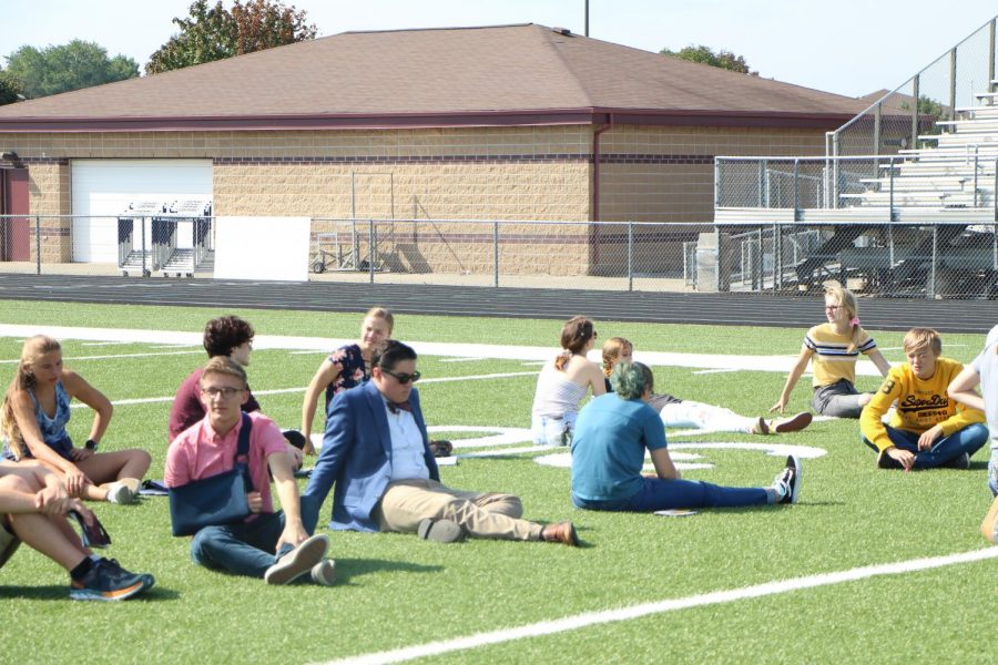 Students enjoying the nice weather, taking a break from marching.