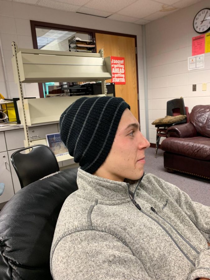 Dominic Gianopoulos, senior at North, wears hat at school. 